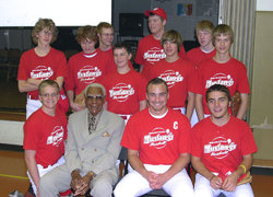 Two months before his final plate appearance, Buck O'Neil poses with the first Monarchs/Mustangs team