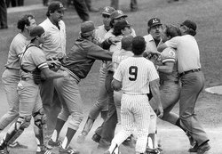 One of the umpires puts George Brett in a choke hold at home plate