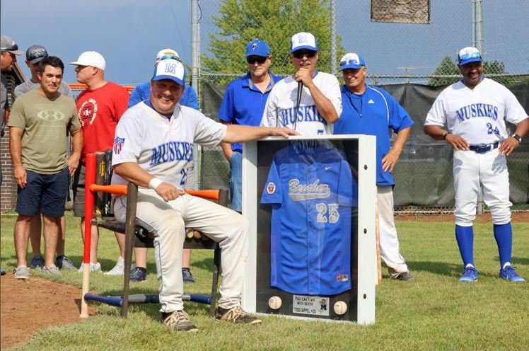 Todd Sippel flashes a smile as he sits in his new retirement chair and listens to a speech from manager Fred LeSage at a surprise jersey retirement.