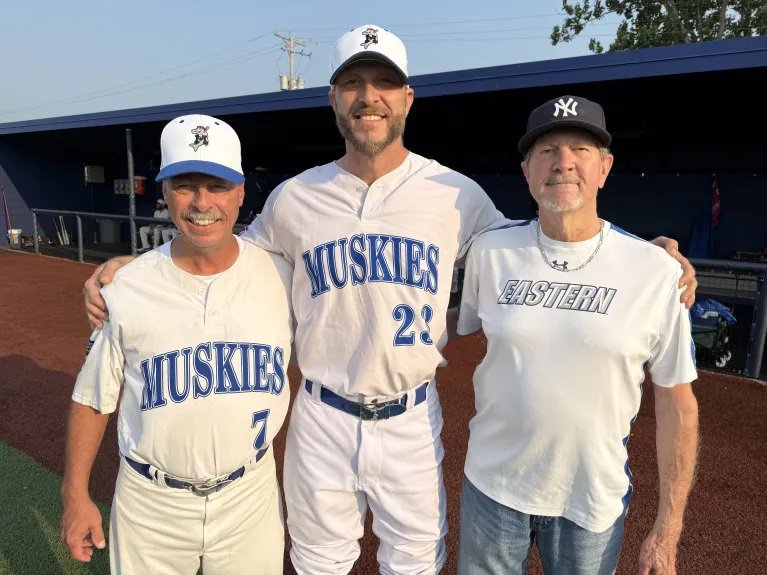 Kris Honel, middle, poses with Beecher Muskies manager Fred LeSage and Honel’s father, Mike, before an NABF World Series pool game in Carol Stream on 