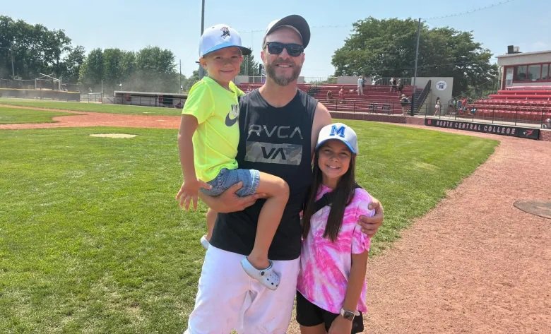 Beecher Muskies pitcher Kris Honel shares a moment with two young fans after throwing a complete game at the NABF Charles Blackburn Major World Series