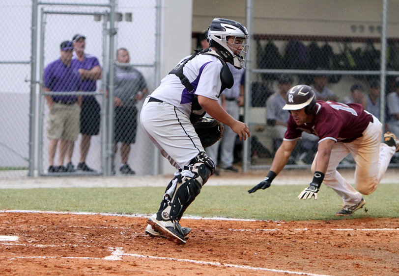 Riverview's Justin Cohen dives into home plate with the Rams first run in the first inning of Tuesday's Class 8A-Region 2 final against Timber Creek. Wolves catcher Trevor Forsberg takes the late throw. STAFF PHOTO / DENNIS MAFFEZZOLI