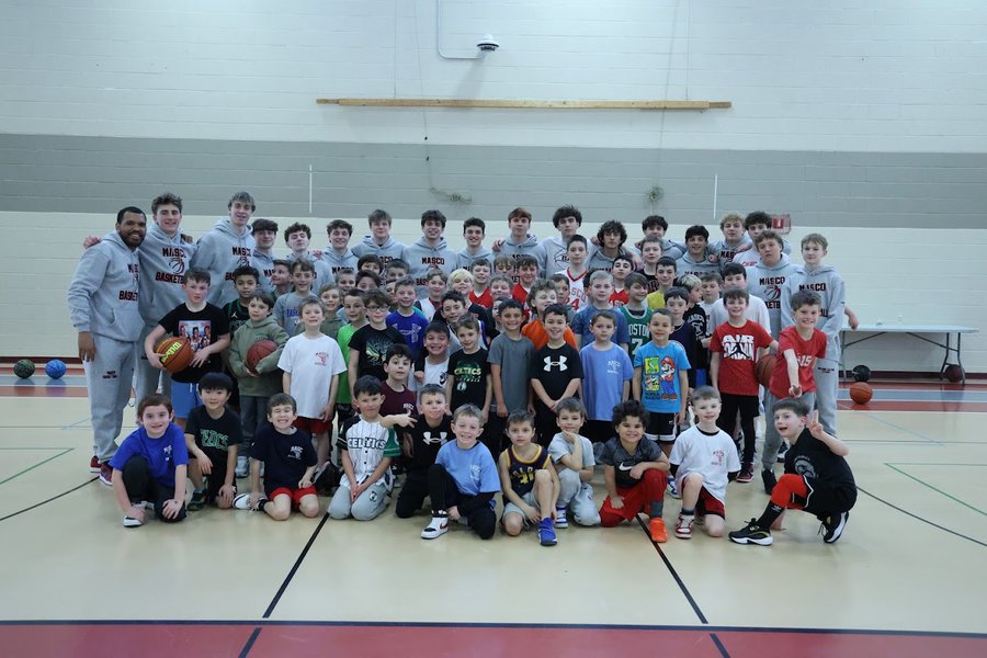 Masco varsity players pose with youth players 