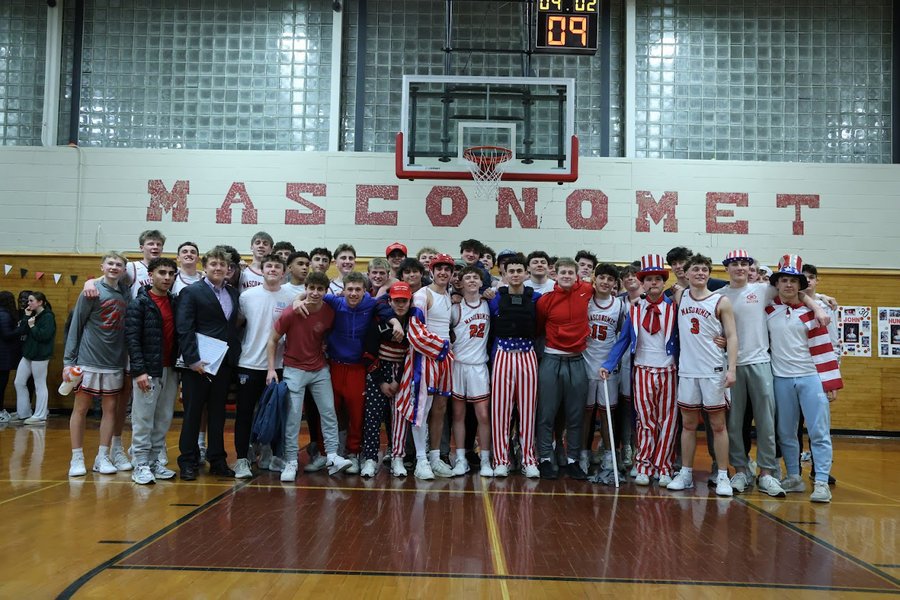 Students pose with the players after the big win