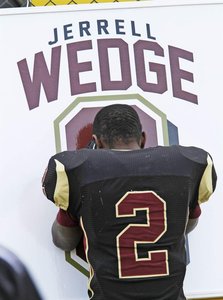 Douglass High School's Akiva Wedge remembers his cousin, Jerrell Wedge, during halftime of the Nov. 29 state semifinal football.  Bill Ryan/The Gazett