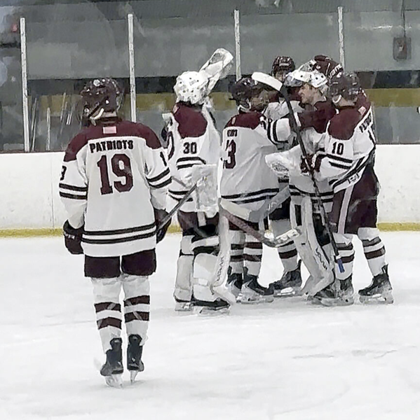 The Concord-Carlisle boys hockey team celebrates i