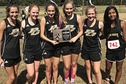 The varsity girls' cross country team celebrates their win at district.