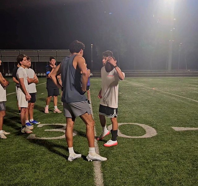 QB Jacob Chami talks things over with WR Toby Levy