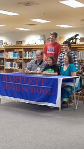 Lexie on signing day with her family and Coach Robby