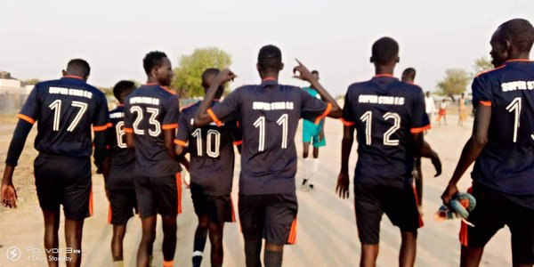 Boys walking on  Bor Town Main Road 