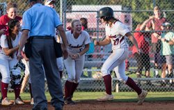 Lambert's Brooke Miller (27) is greeted by teammates after hitting a home run in the state playoffs against Hillgrove.